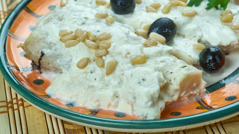 Baked fish with tahini sauce and pine nuts