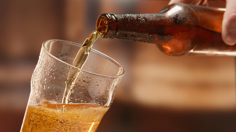 Beer being poured into glass from bottle