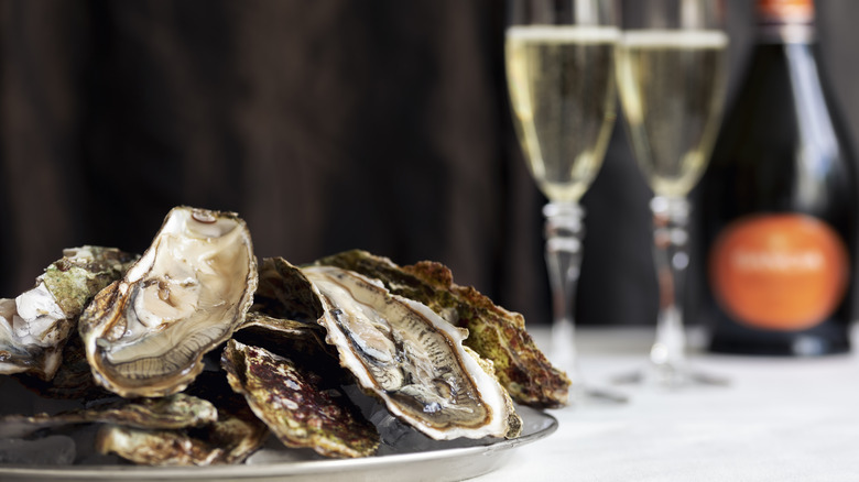 platter of oyster shells and flutes of champagne