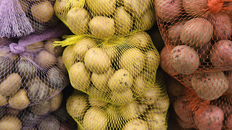 purple, yellow and red sacks full of potatoes