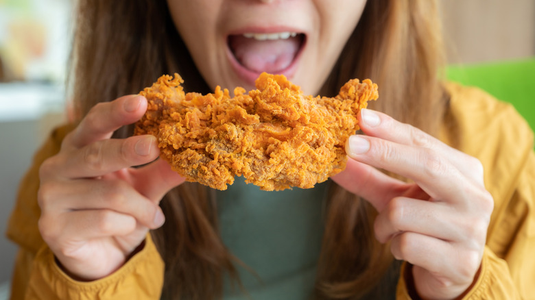 person getting ready to eat fried chicken