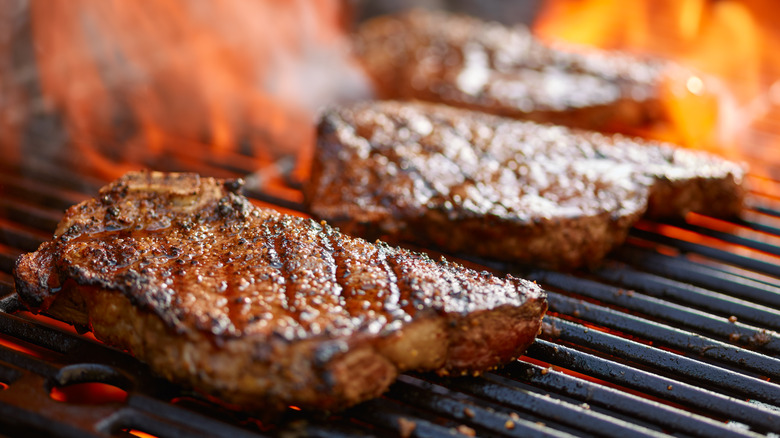 steak on grill, sizzling