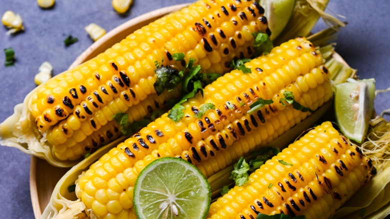 grilled corn on plate with lime