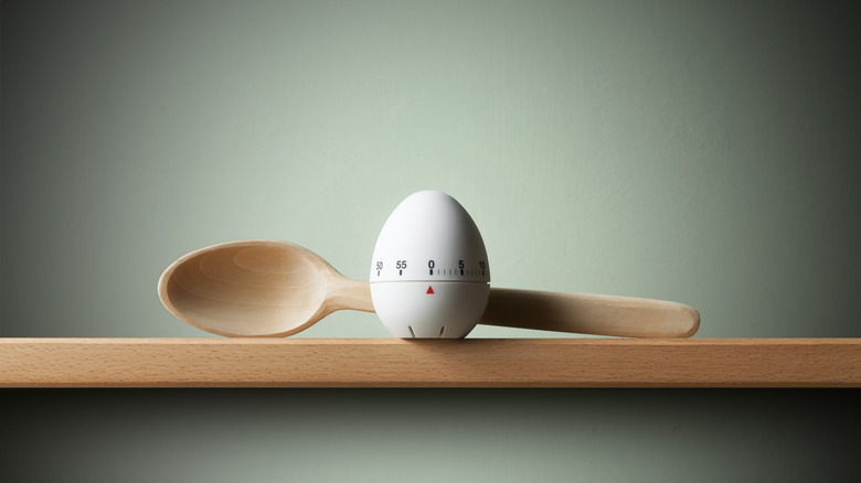 kitchen timer and wooden spoon