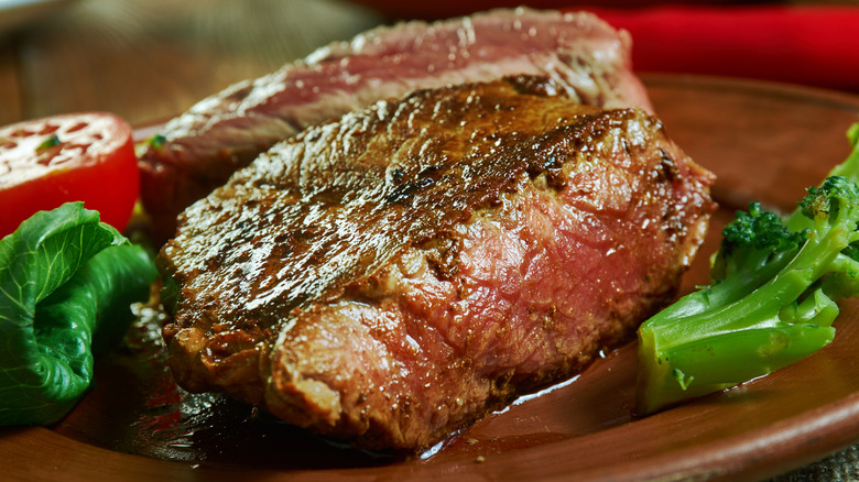 Pittsburgh rare steak on a plate with some vegetables