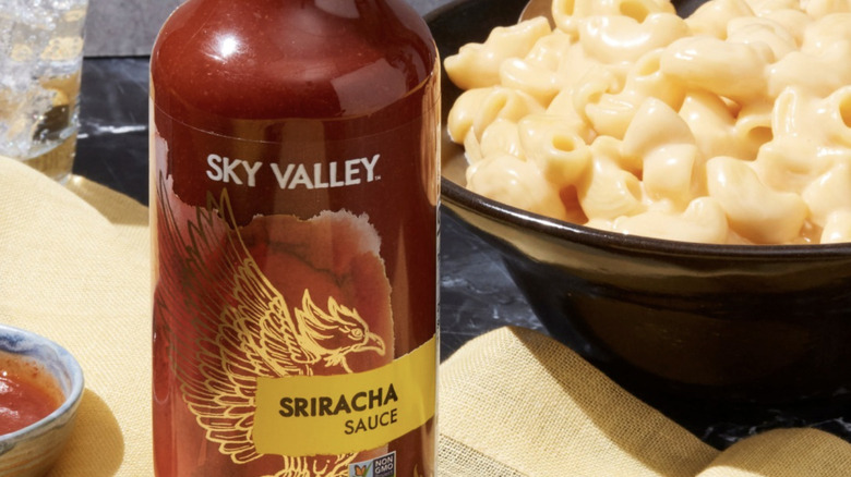 Sky Valley Sriracha next to bowl of macaroni and cheese