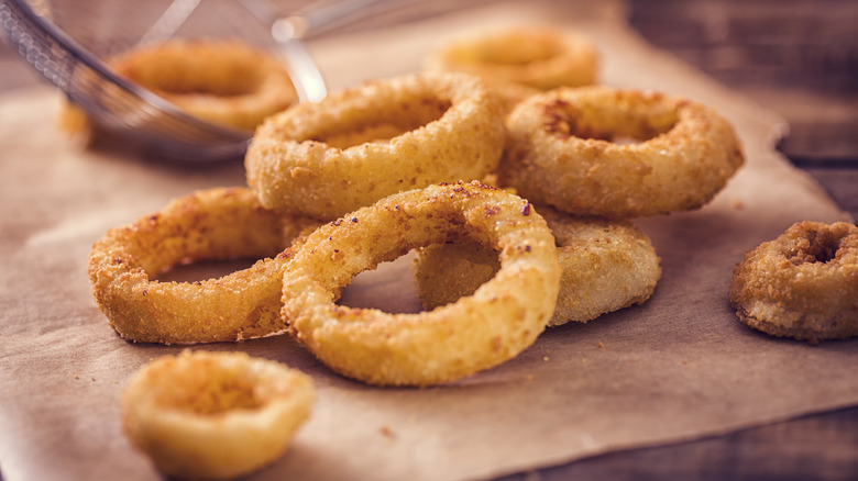 Freshly made onion rings on brown paper