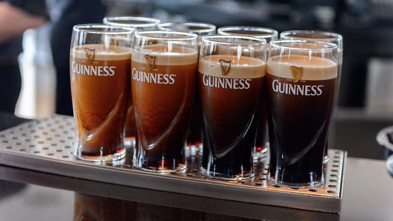 Pints glasses of Guinness on a metal table