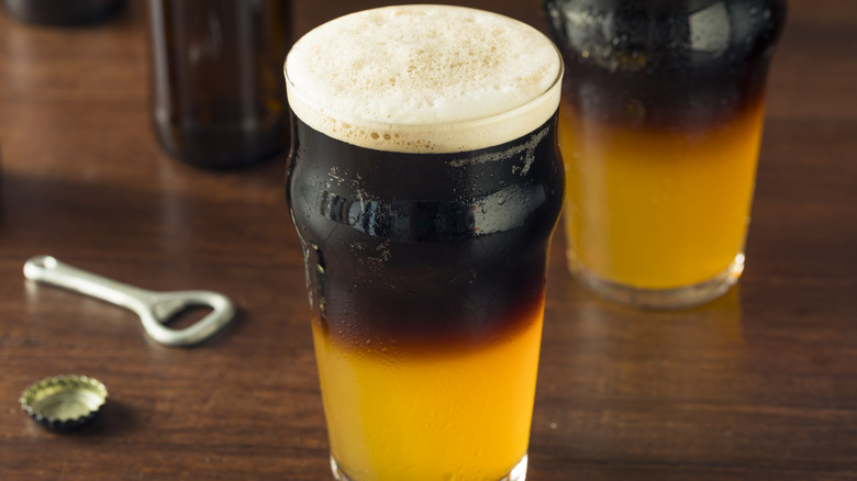 Black and tan cocktail in pint glass
