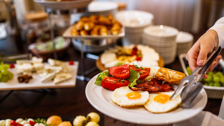 filling plate at breakfast buffet