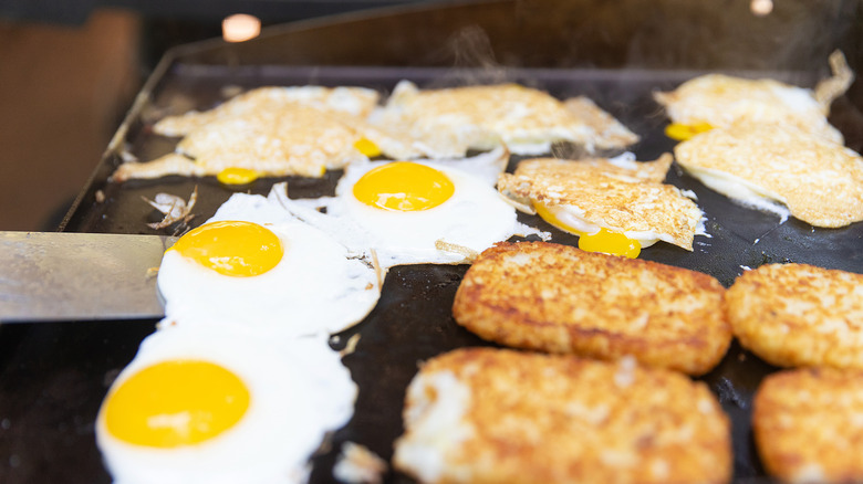 eggs and hash browns on griddle