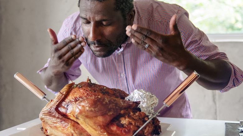 man smelling turkey