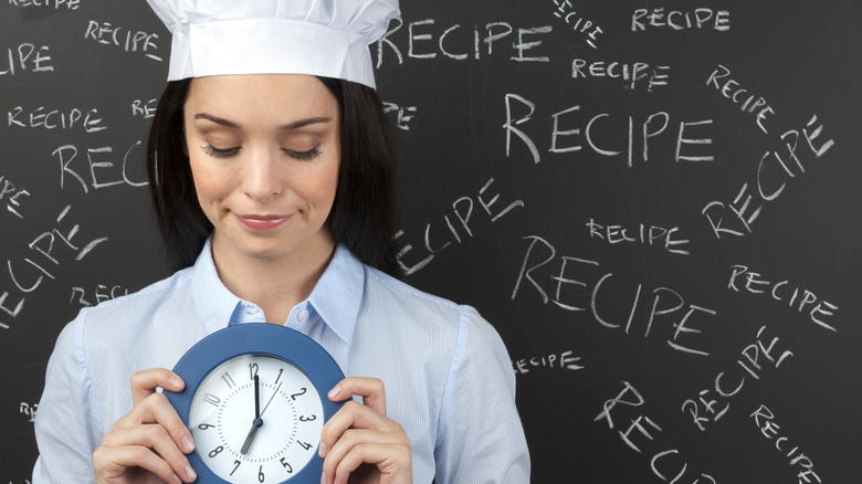 chef holding a clock