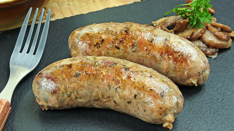 Andouillettes with mushrooms and fork