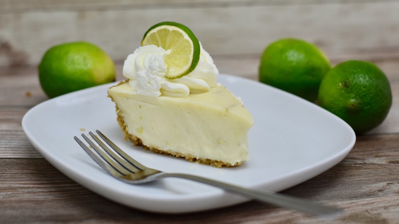 Key lime pie on white plate with fork