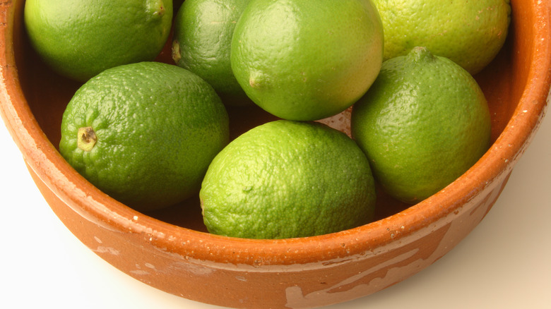 Wooden bowl of limes