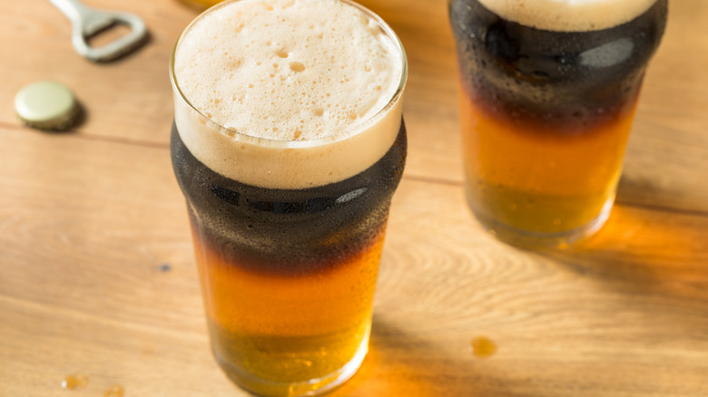 black and tan beers on wooden tabletop