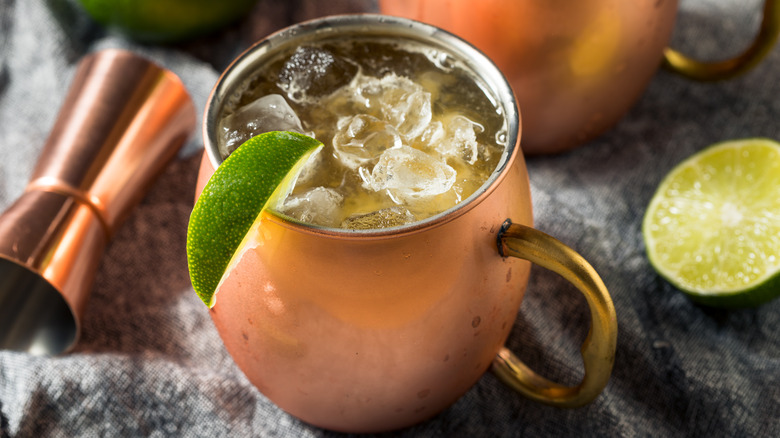 copper mug with lime drink and jigger