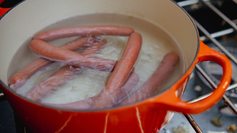 Boiling hot dogs in pot