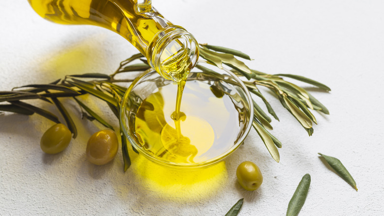 Pouring olive oil into bowl