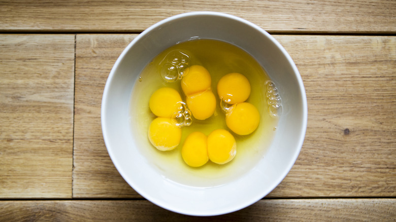 Bowl of raw cracked eggs