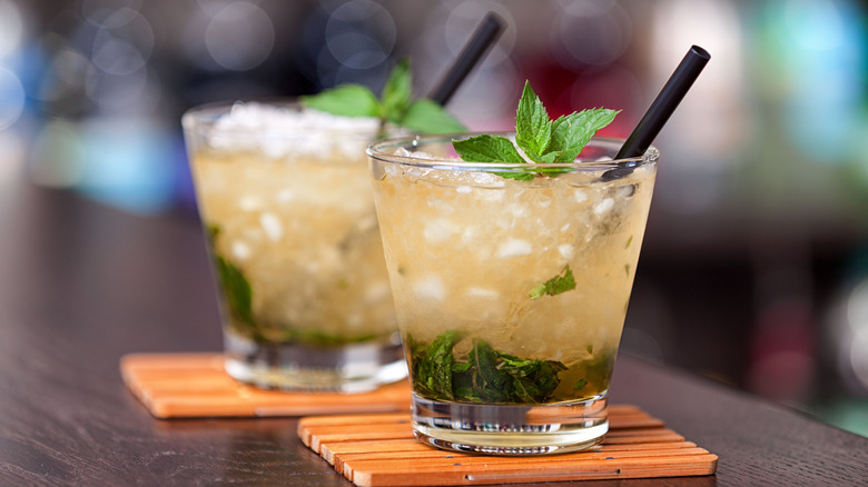Mint juleps in glass with straw