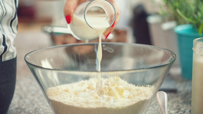 pouring milk into cake mix
