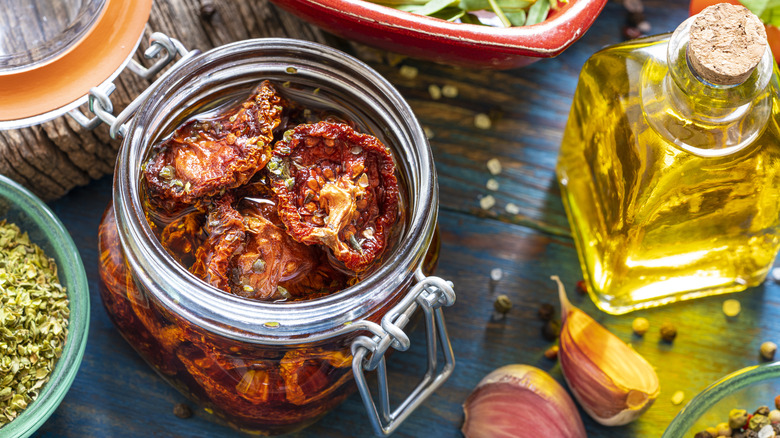 open jar of sun dried tomatoes in oil with capers