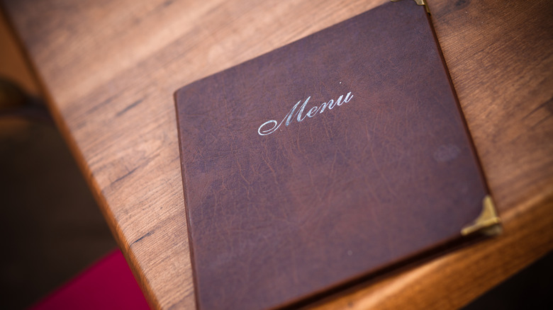 bound menu on a wooden table