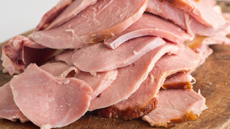 carved ham on a wooden board