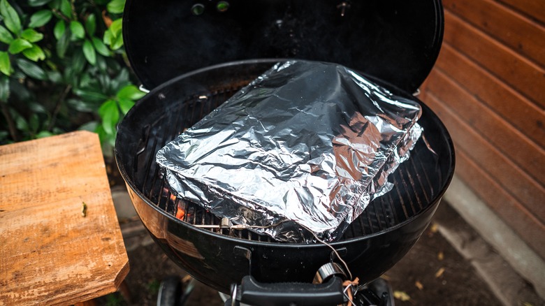 ribs wrapped in foil on grill