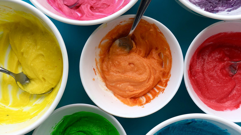bowls filled with different colors of frosting