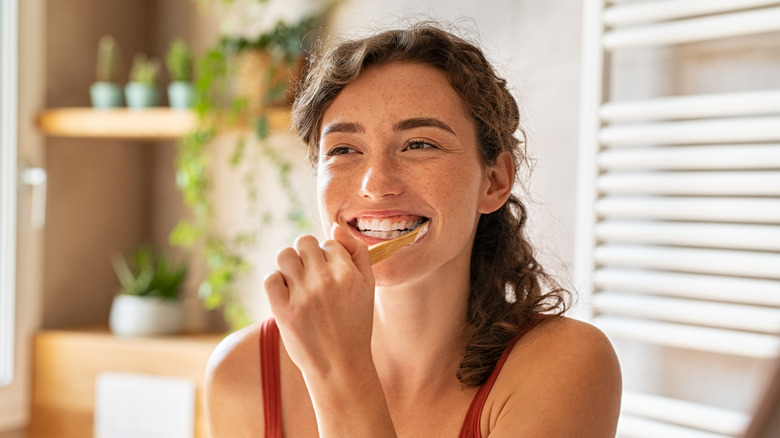 person brushing teeth