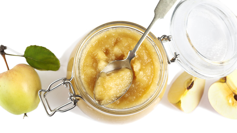 jar and spoon of applesauce