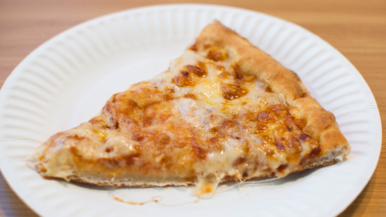 Slice of pizza on a paper plate