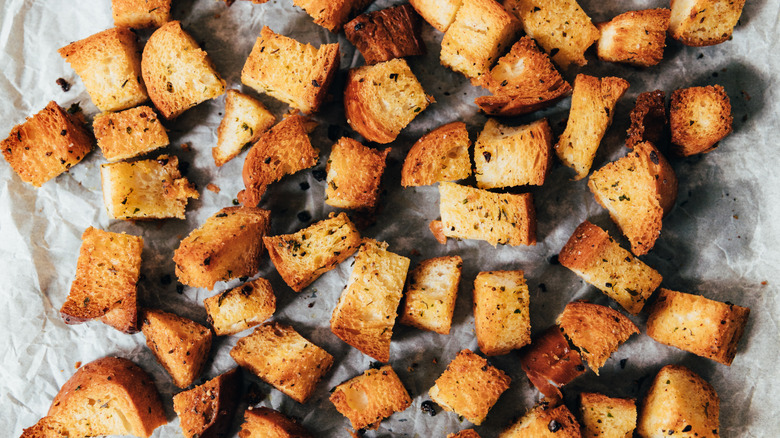 Seasoned bread croutons on parchment paper