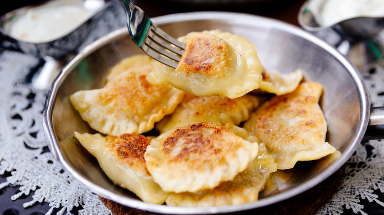 Fork picking up crispy pierogi