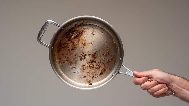 Home cook holding dirty frying pan