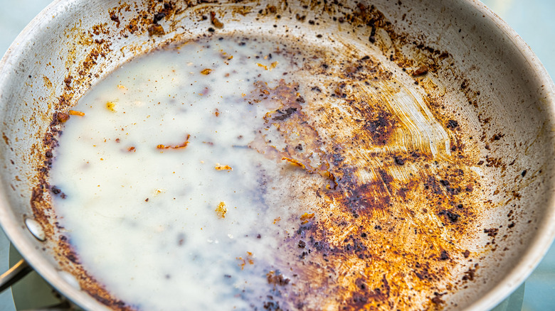 Bacon grease pooling on a used frying pan