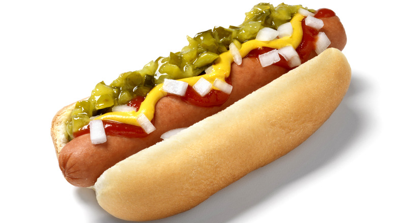 a classic hot dog topped with relish, onions, mustard and ketchup