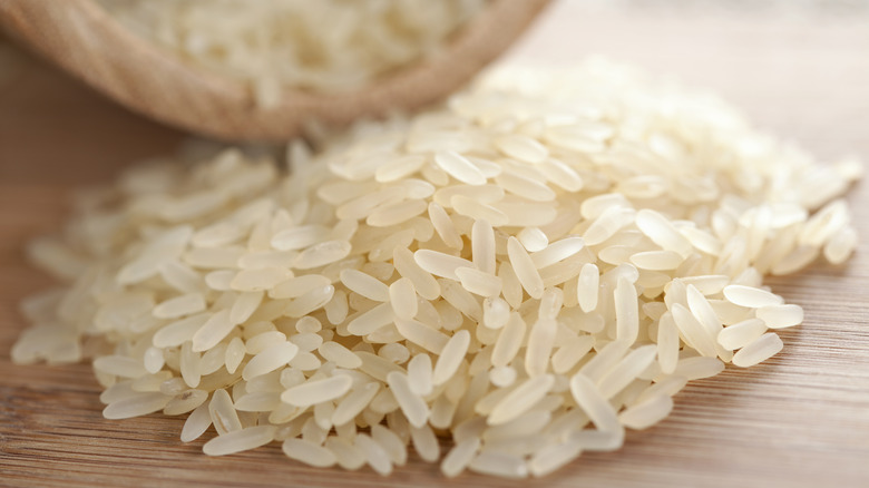 Raw rice on a wooden table