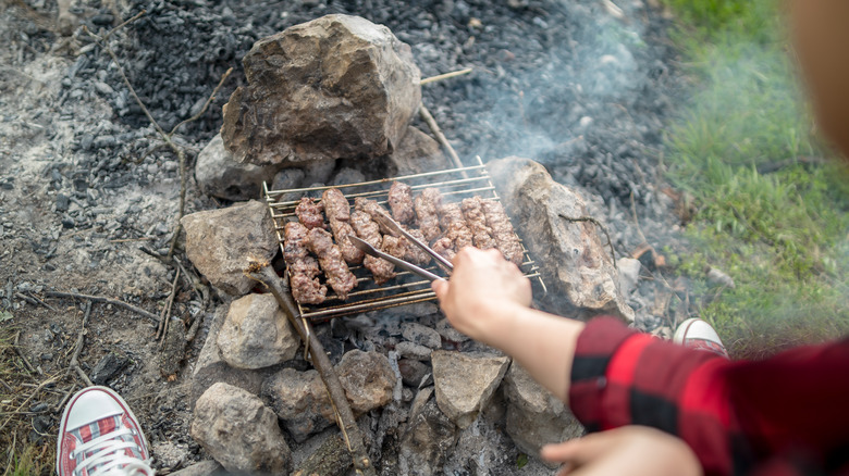 bush meat being cooked on a grill