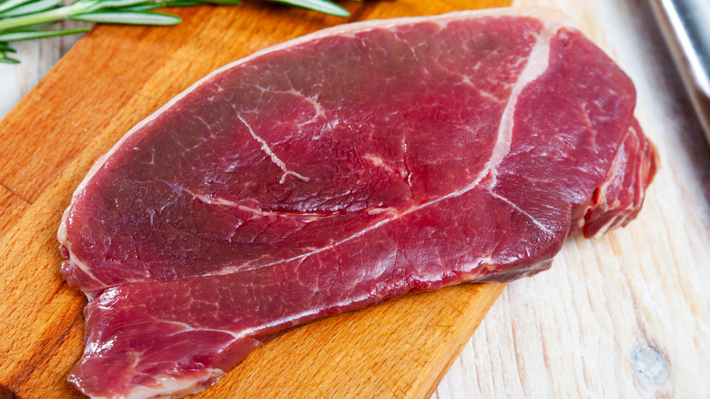 slice of fresh horsemeat on cutting board