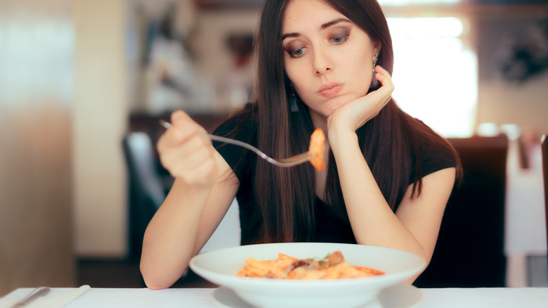 woman doesn't want to eat pasta