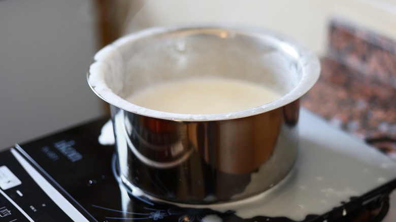 Milk boiling over pan