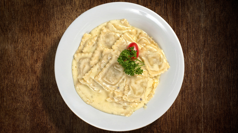 Bowl of ravioli with creamy alfredo sauce