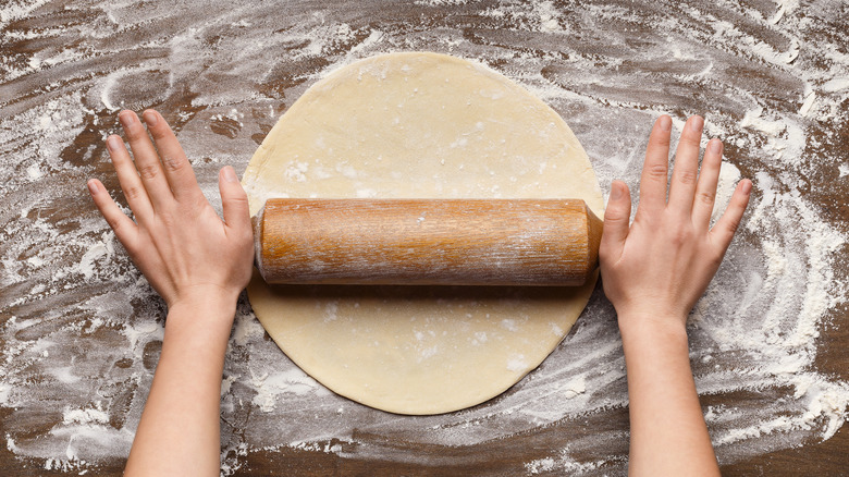 Person rolling out homemade pastry