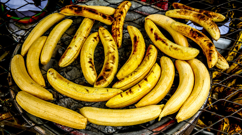 Plantains cooking on coal grill