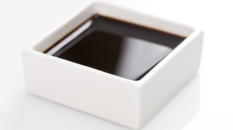 soy sauce in a square bowl