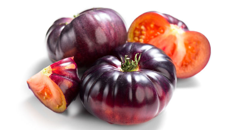 Whole and halved Blue Beauty tomatoes